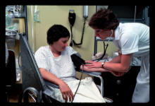 Nurse taking a patient's blood pressure.  Photo courtesy of National Institutes of Health.